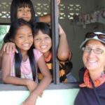 Volunteer with children at Burmese Learning Center