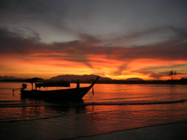 A Moken family's long tail boat on the coast of Andaman Sea