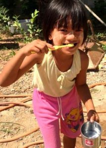 Burmese Migrant school kid with new toothbrush