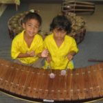 Children learning traditional Thai musical instrument - Andaman Discoveries