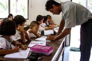 Burmese migrant education program in Kuraburi - a teacher leading a class